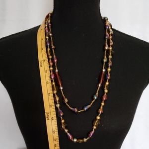 Iridescent beaded double necklace.